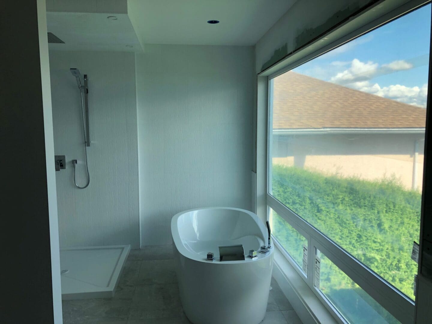 A bathroom with a large window and a tub