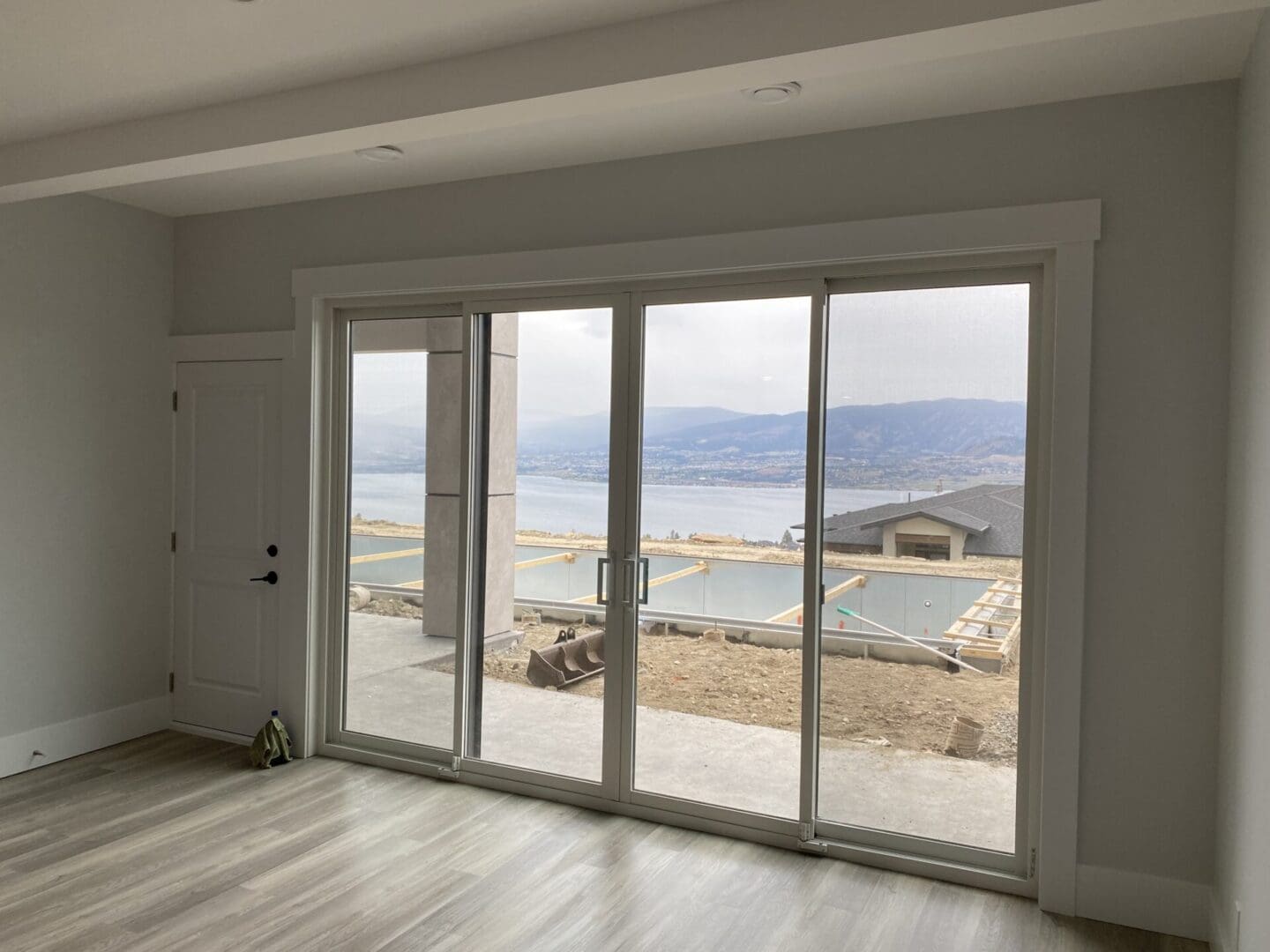 A room with sliding glass doors and a view of the water.