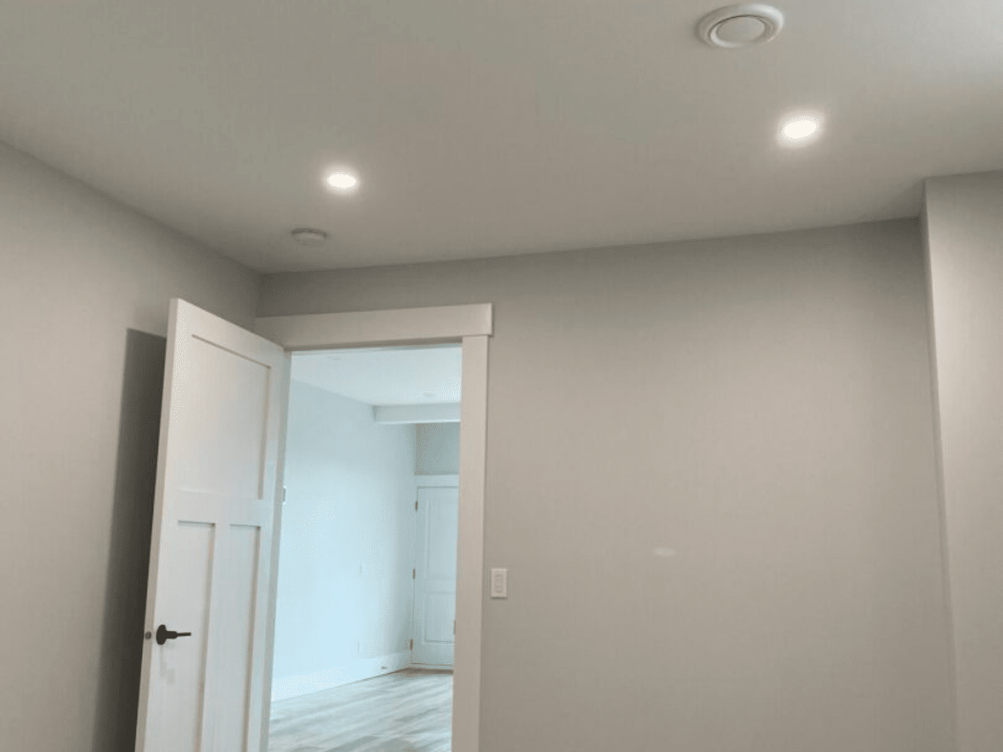 A room with white walls and ceiling lights.